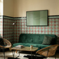 Living room with green sofa, wicker chairs, and patterned wallpaper.olive – Bold Abstract Canvas Print | Large Luxury Wall Art | Brume Art