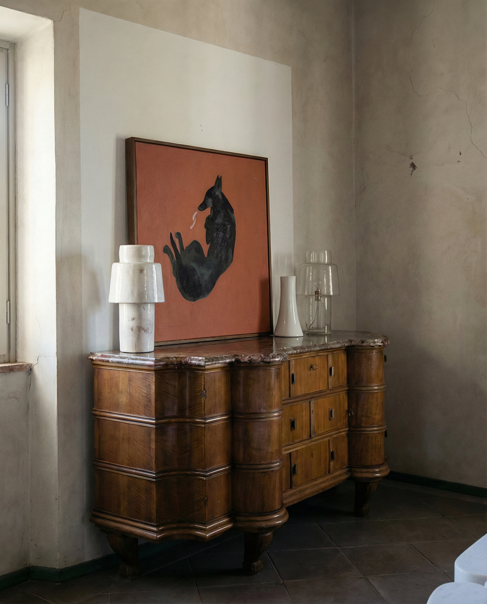 Wooden sideboard with a painting of a dog on an orange background in a room with textured walls. Black dog – Contemporary Animal Canvas Art | Luxury Wall Decor | Brume Art | Luxury Wall Decor | Large Canvas Wall Art | Oversized Wall Hanging-Brume art