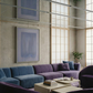 Modern living room with blue and purple sofas, abstract art on the wall, and a coffee table. Frame – Bold Abstract Canvas Wall Art | Large Luxury Print | Brume Art