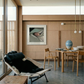 Modern interior with a lounge chair, dining table, and artwork on a wall. Gaze – Figurative Canvas Wall Art | Premium Luxury Print | Brume Art | Luxury Wall Decor | Large Canvas Wall Art | Oversized Wall Hanging-Brume art