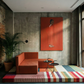 Modern living room with orange sofa, colorful rug, and red wall art. The Woman in Red – Portrait Canvas Wall Art | Large Luxury Print | Brume Art