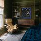 Modern living room with a blue sofa, beige armchair, and abstract painting on a green wall. Noise 5 – Bold Abstract Canvas Print | Large Luxury Wall Art | Brume Art