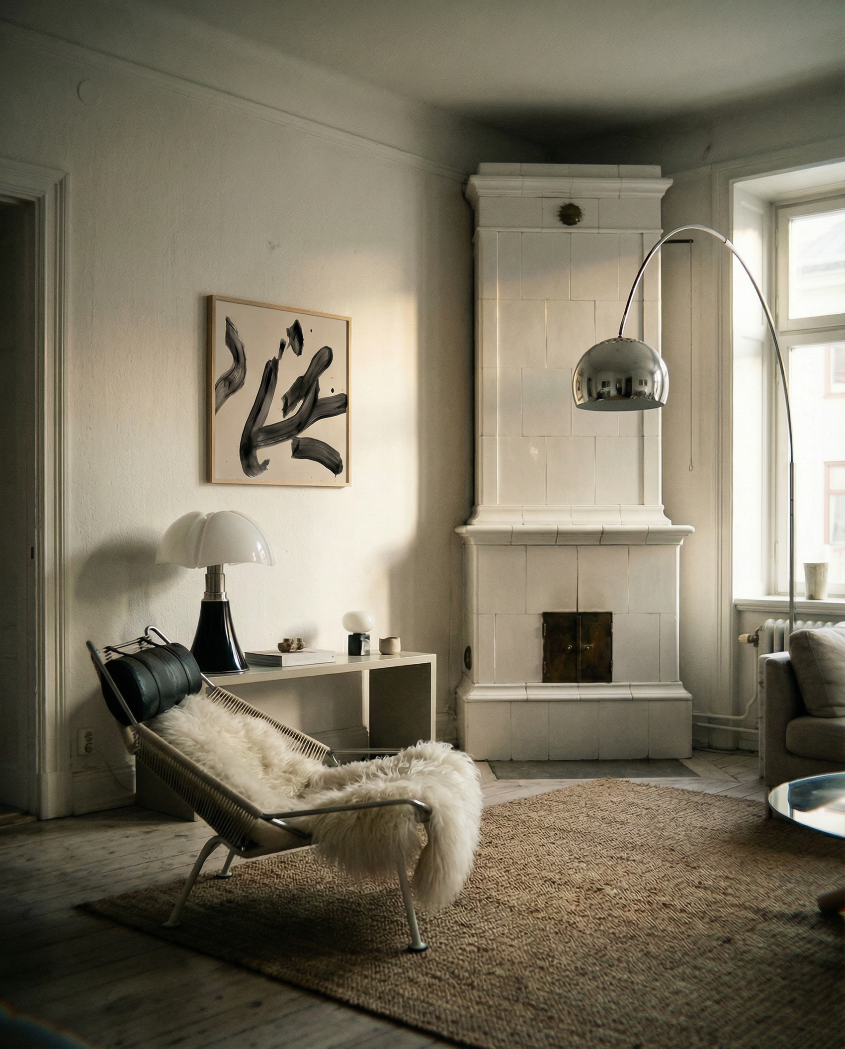 Modern living room with a fireplace, chair, and abstract art on the wall. Ink 3 – Abstract Ink Canvas Wall Art | Oversized Luxury Print | Brume Art | Luxury Wall Decor | Large Canvas Wall Art | Oversized Wall Hanging-Brume art