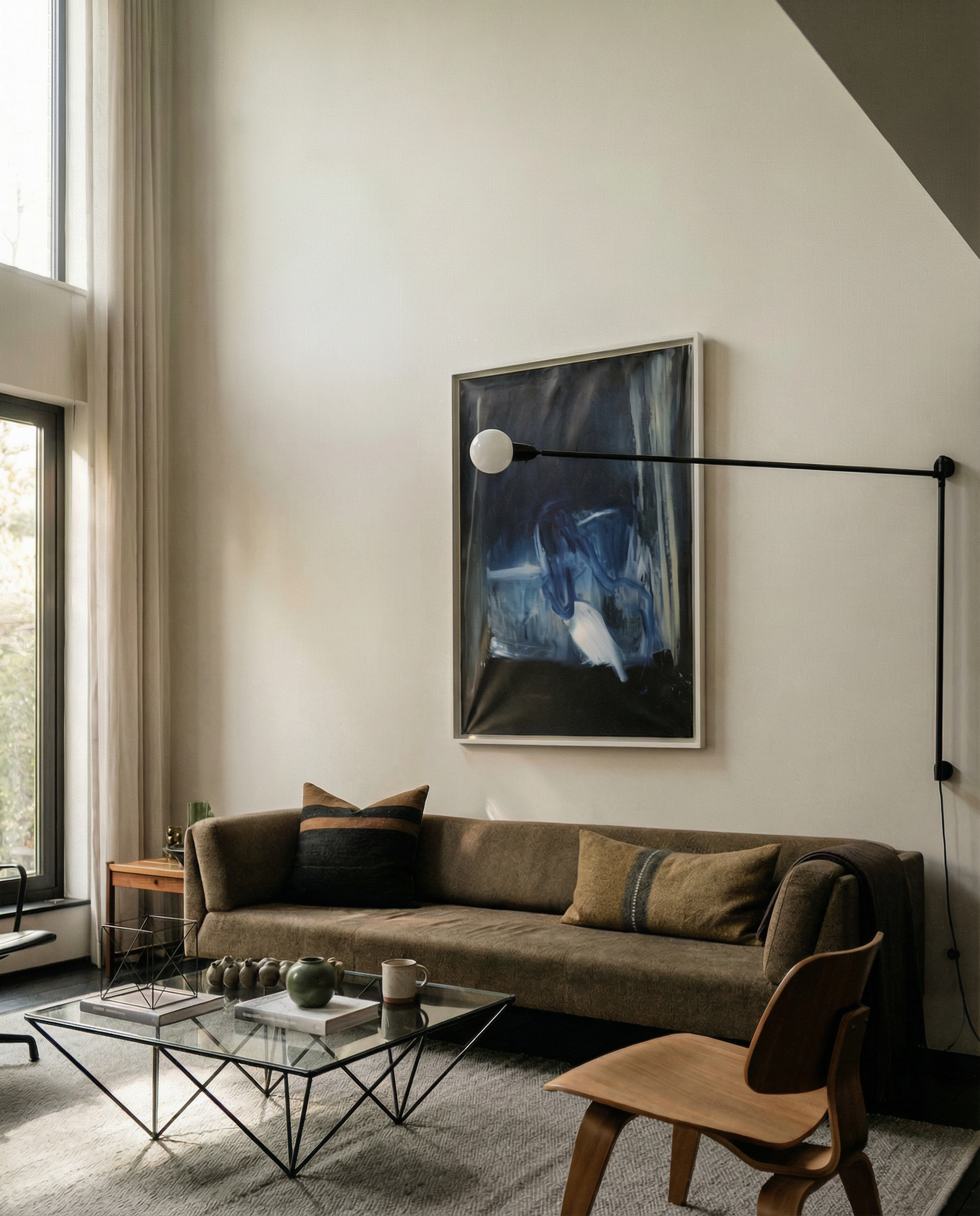 Modern living room with a brown sofa, abstract painting, and glass coffee table. Field black – Landscape Canvas Wall Art | Large Luxury Print | Brume Art