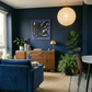 Living room with blue walls, a blue sofa, and a wooden sideboard. Noise 5 – Bold Abstract Canvas Print | Large Luxury Wall Art | Brume Art