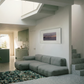 Modern living room with a gray sectional sofa, framed artwork on the wall, and a kitchen in the background. Away – Minimalist Abstract Canvas Art | Large Luxury Wall Decor | Brume Art