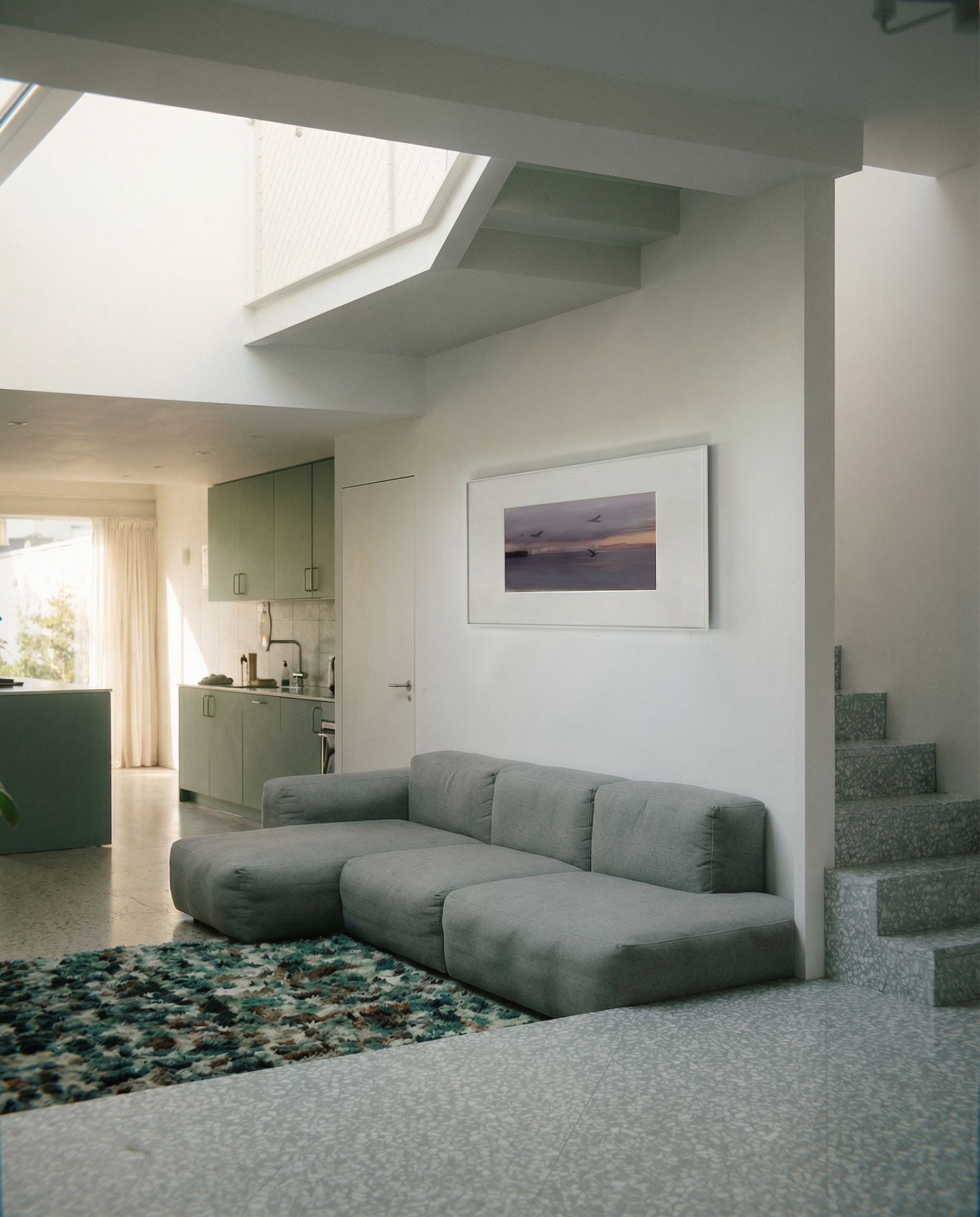 Modern living room with a gray sectional sofa, framed artwork on the wall, and a kitchen in the background. Away – Minimalist Abstract Canvas Art | Large Luxury Wall Decor | Brume Art