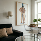 Modern living room with a black sofa, glass coffee table, and wall art. Man bathing – Portrait Canvas Wall Art | Large Luxury Print | Brume Art