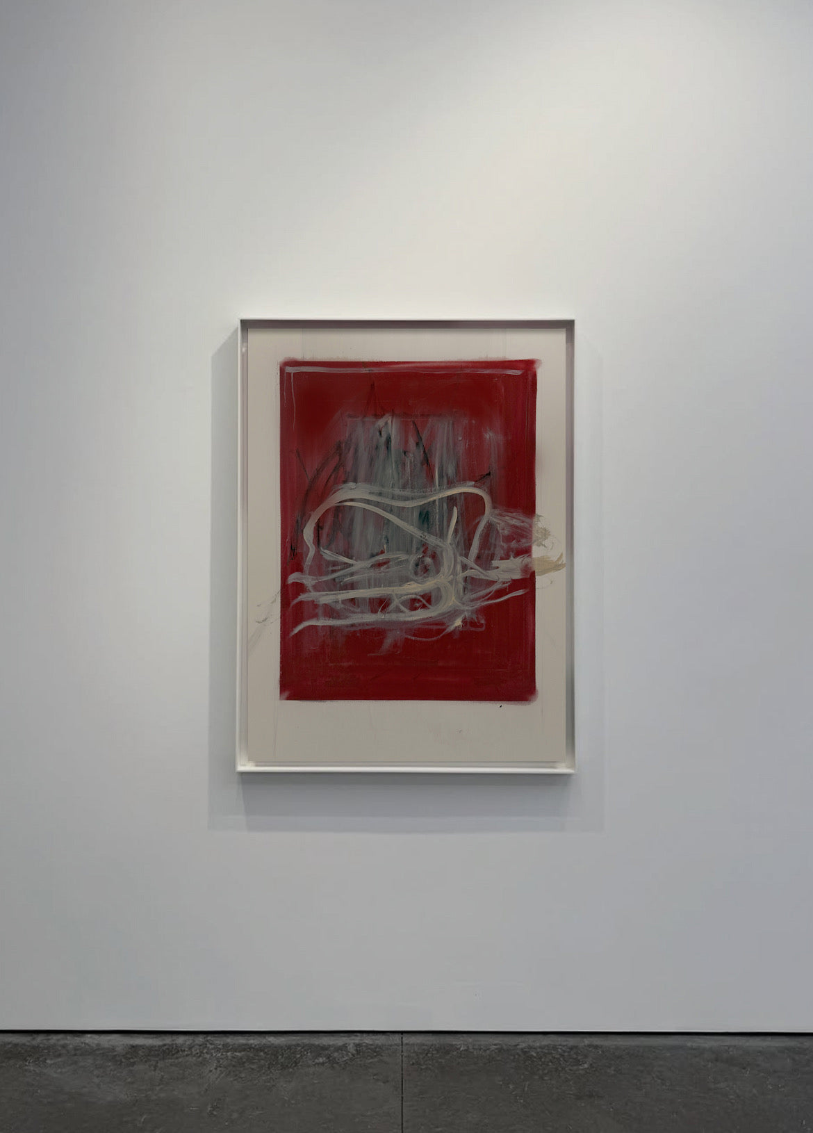 Abstract artwork on a red background in a white frame against a gray wall. Tension – Bold Abstract Canvas Print | Large Luxury Wall Art | Brume Art