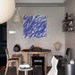 Modern dining room with a round table and chairs, abstract blue painting on the wall, and decorative items. Noise 3 – Textured Abstract Canvas Art | Premium Luxury Wall Decor | Brume Art | Luxury Wall Decor | Large Canvas Wall Art | Oversized Wall Hanging-Brume art