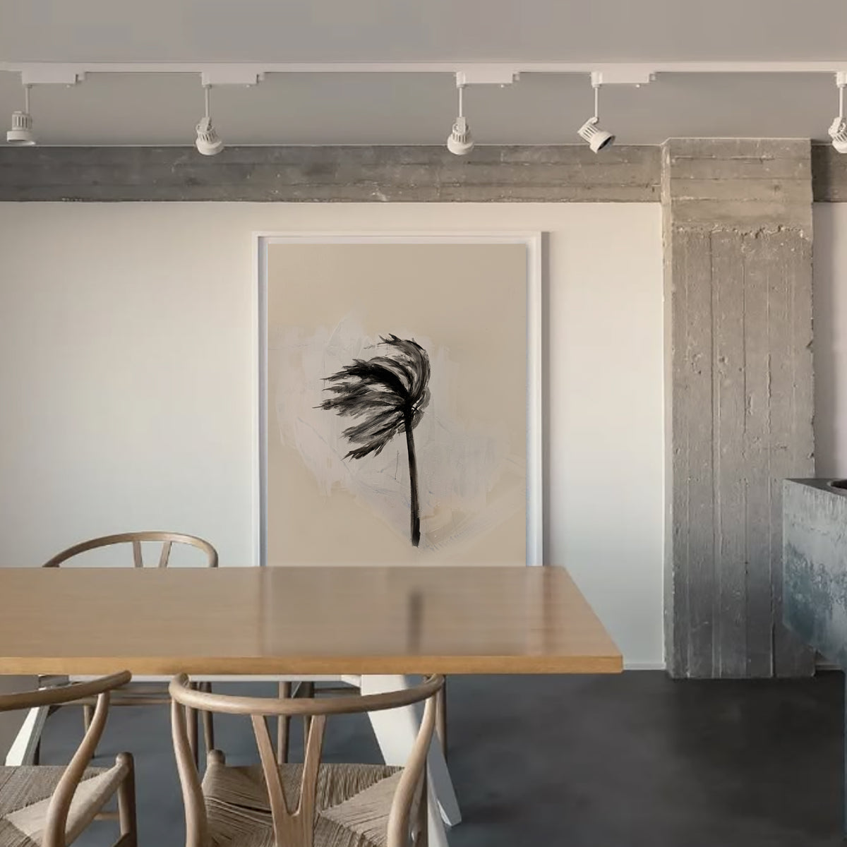 A large framed art print featuring a black palm frond illustration on a textured beige background, displayed on a white wall in a modern dining room setting with a wooden table and chairs.