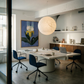 Modern office with a round table and chairs, featuring a large light fixture and artwork on the wall. Iris – Botanical Canvas Wall Art | Premium Luxury Print | Brume Art