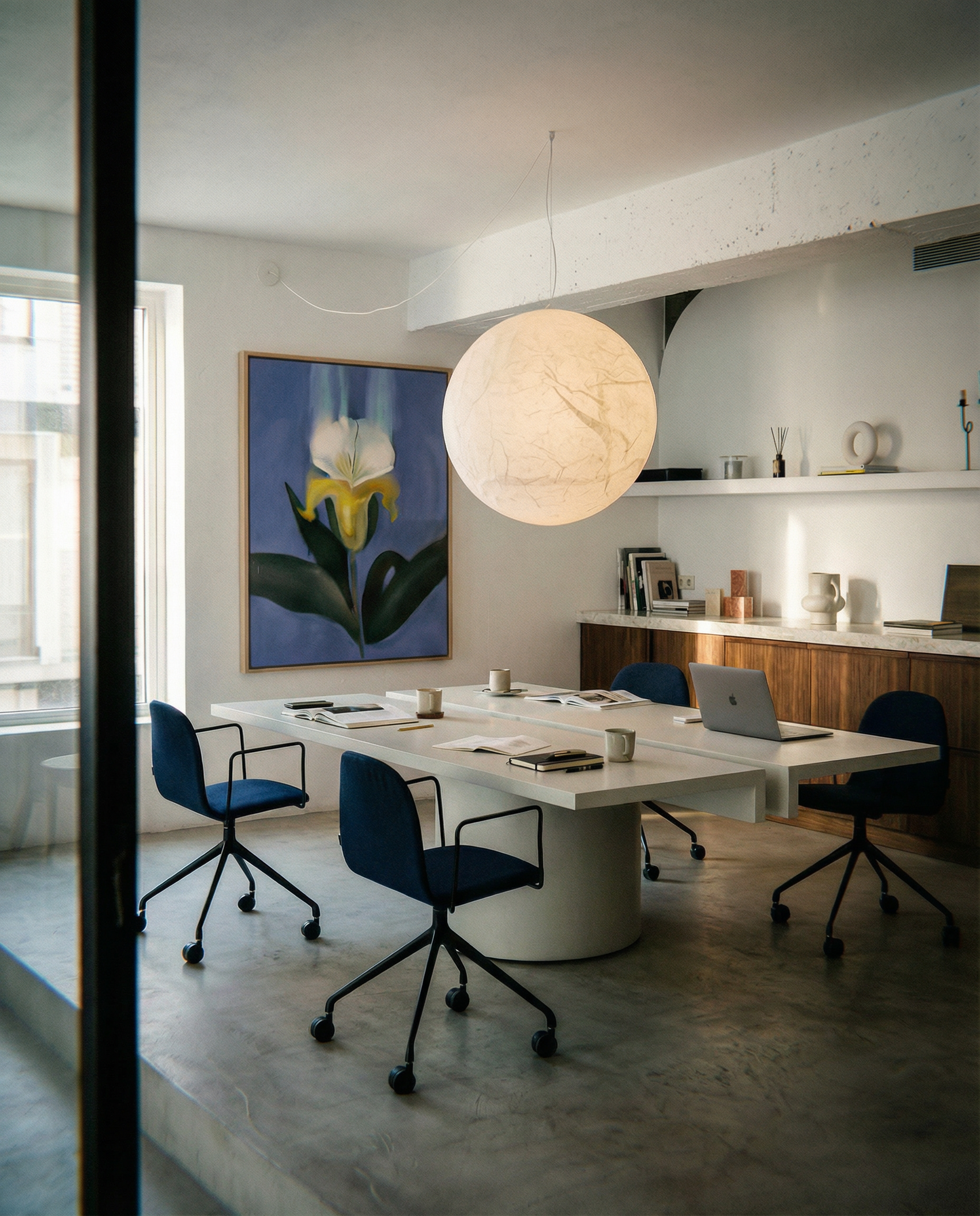 Modern office with a round table and chairs, featuring a large light fixture and artwork on the wall. Iris – Botanical Canvas Wall Art | Premium Luxury Print | Brume Art