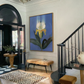 Staircase with a large floral painting on the wall, wooden floor, and decorative elements. Iris – Botanical Canvas Wall Art | Premium Luxury Print | Brume Art